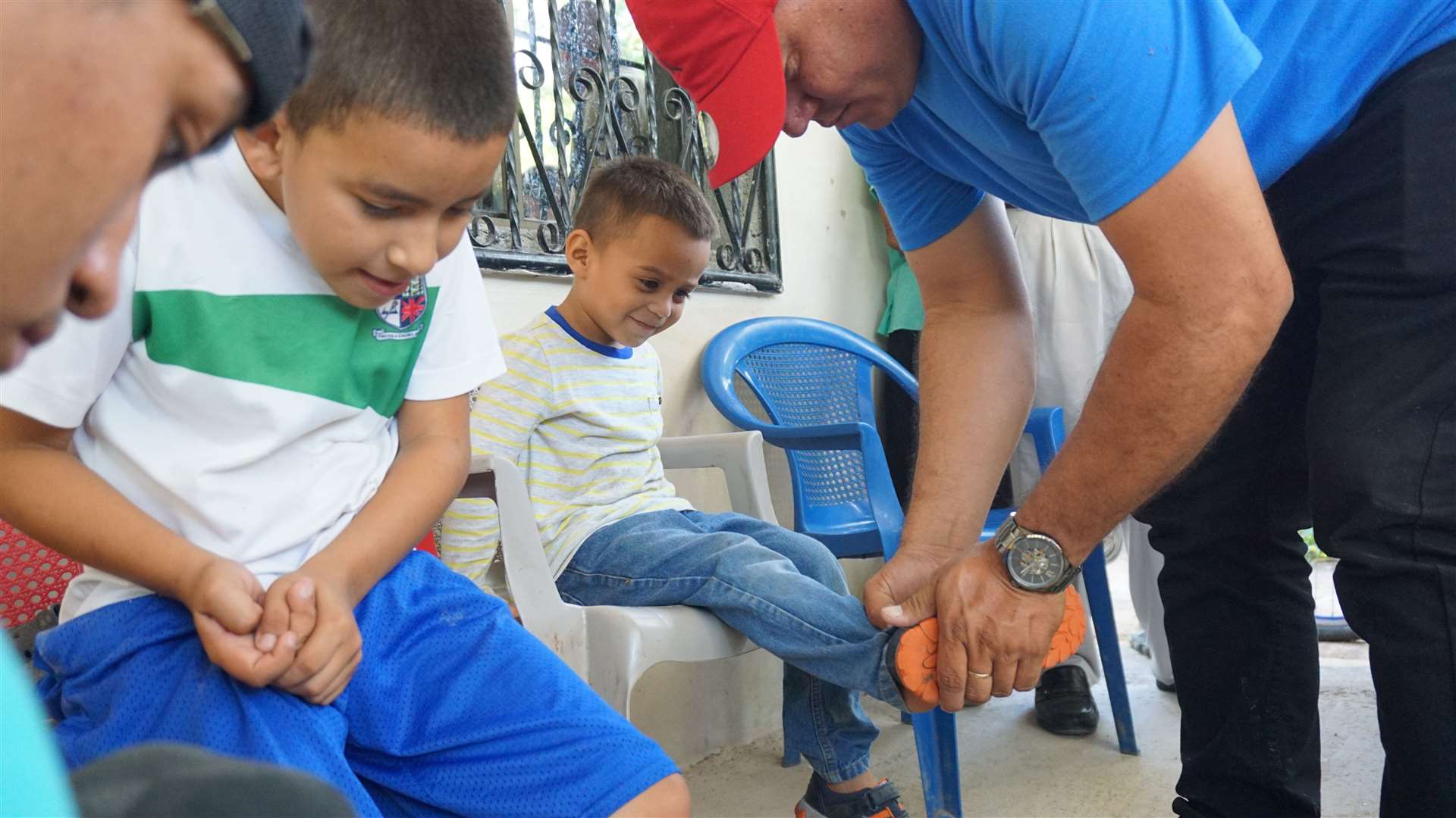 Children in Nicaragua being fitted with donated shoes