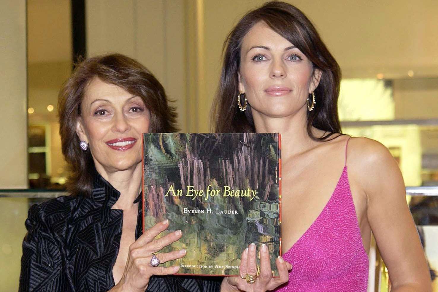 The late Evelyn Lauder, left, and ambassador Elizabeth Hurley at a book signing