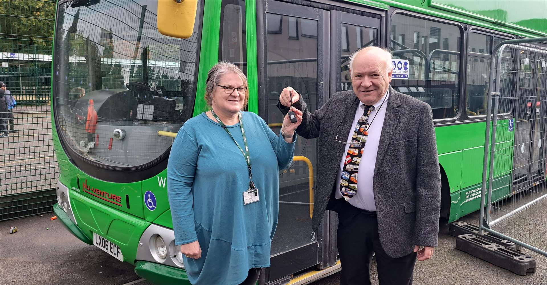 School principal Peggy Murphy accepts the keys to the bus from Norman Kemp