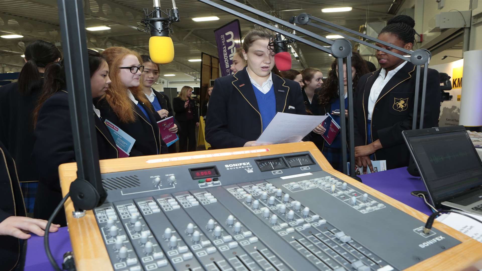 Pupils have a go at news reading on the kmfm stand at last year's Kent Choices Live