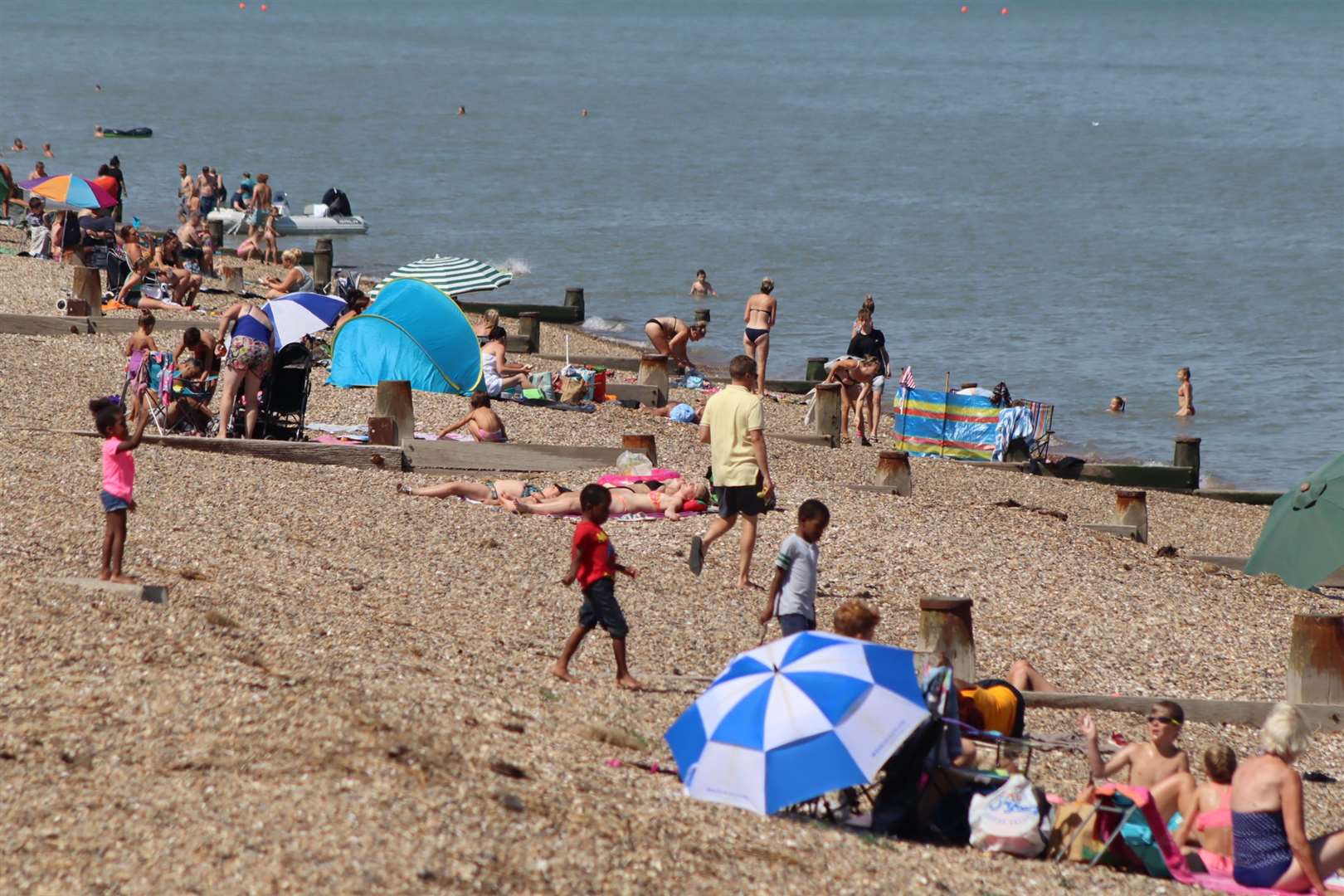 Bathers at The Leas at Minster on Sheppey on one of the hottest days of 2020