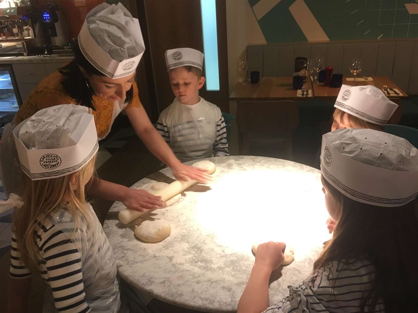 Suzy, manager of Bluewater's latest Pizza Express restaurant takes the children through the process of making a pizza
