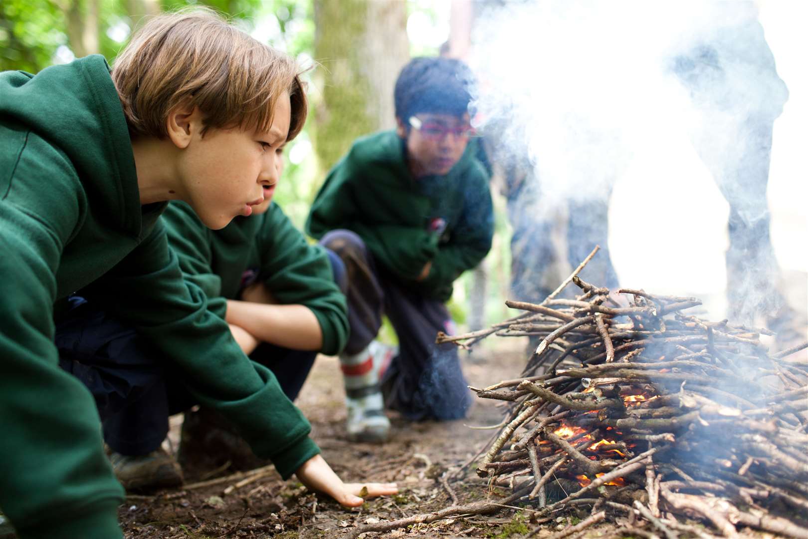 Children can build and then learn how to cook over open fires.