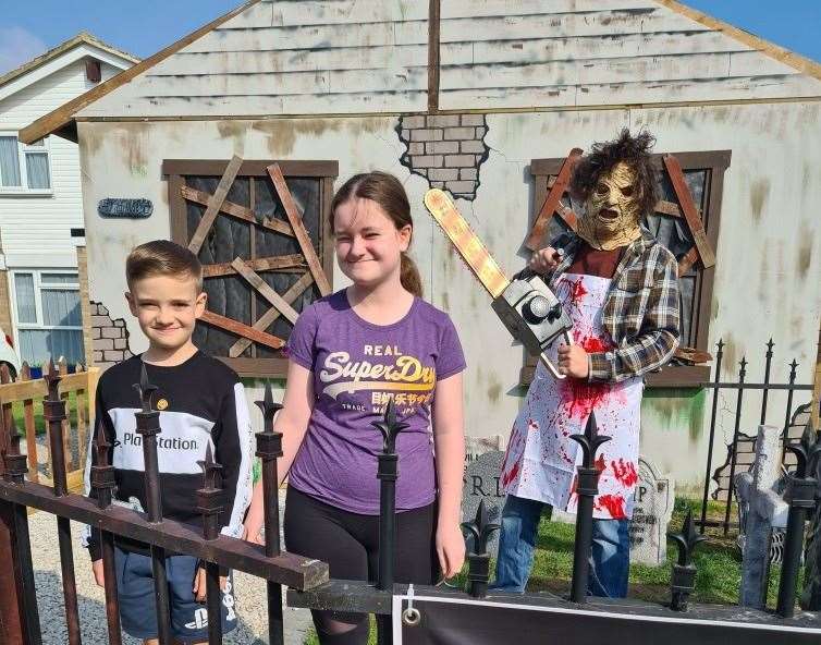Jessica, George and Robert Amey outside this year’s spooky haunted house display