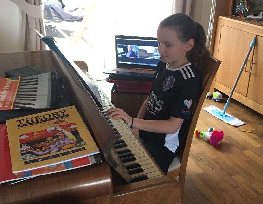 Amy has a virtual piano lesson