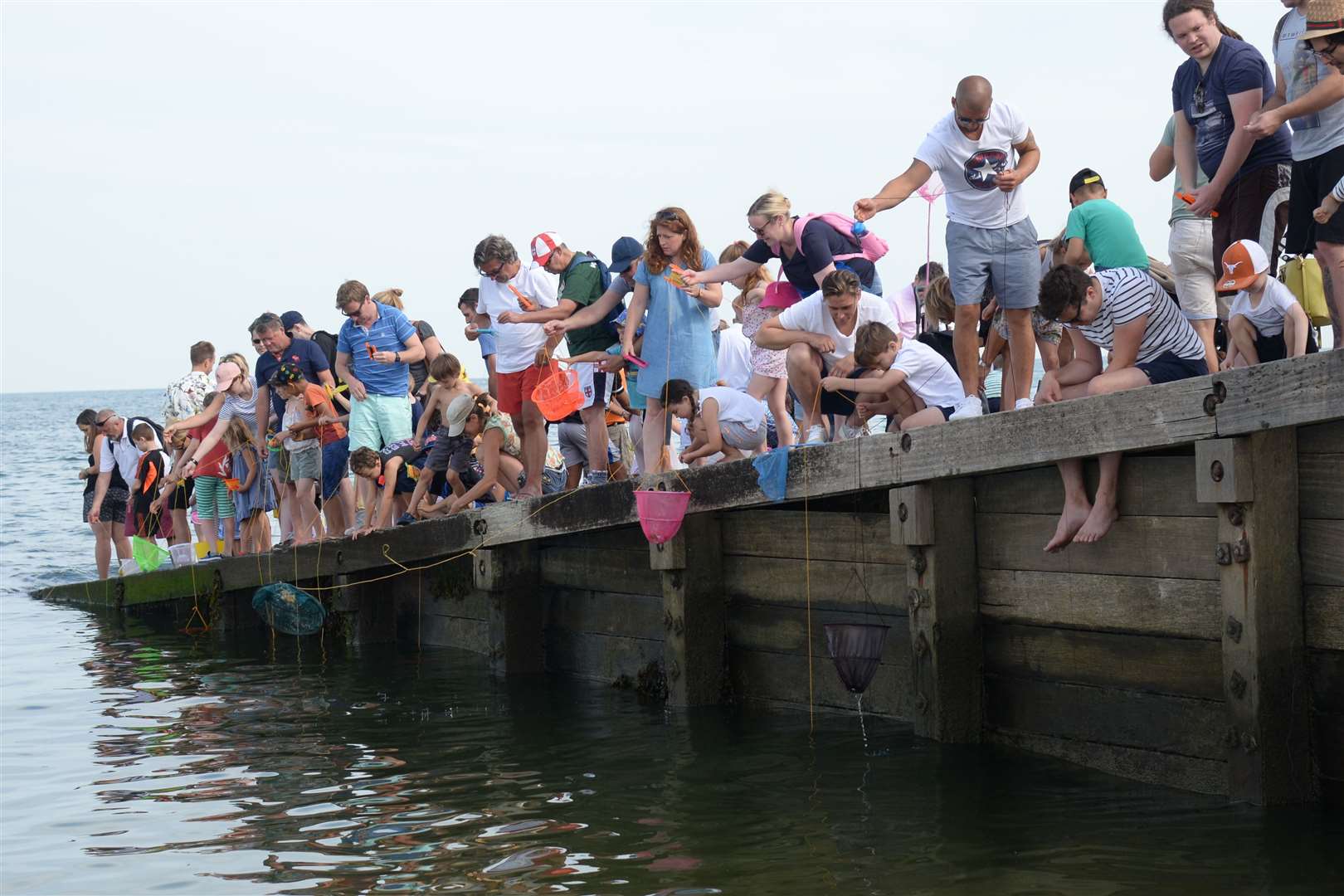 Families crabbing in Whitstable during the Oyster Festival Crab Catching Competition