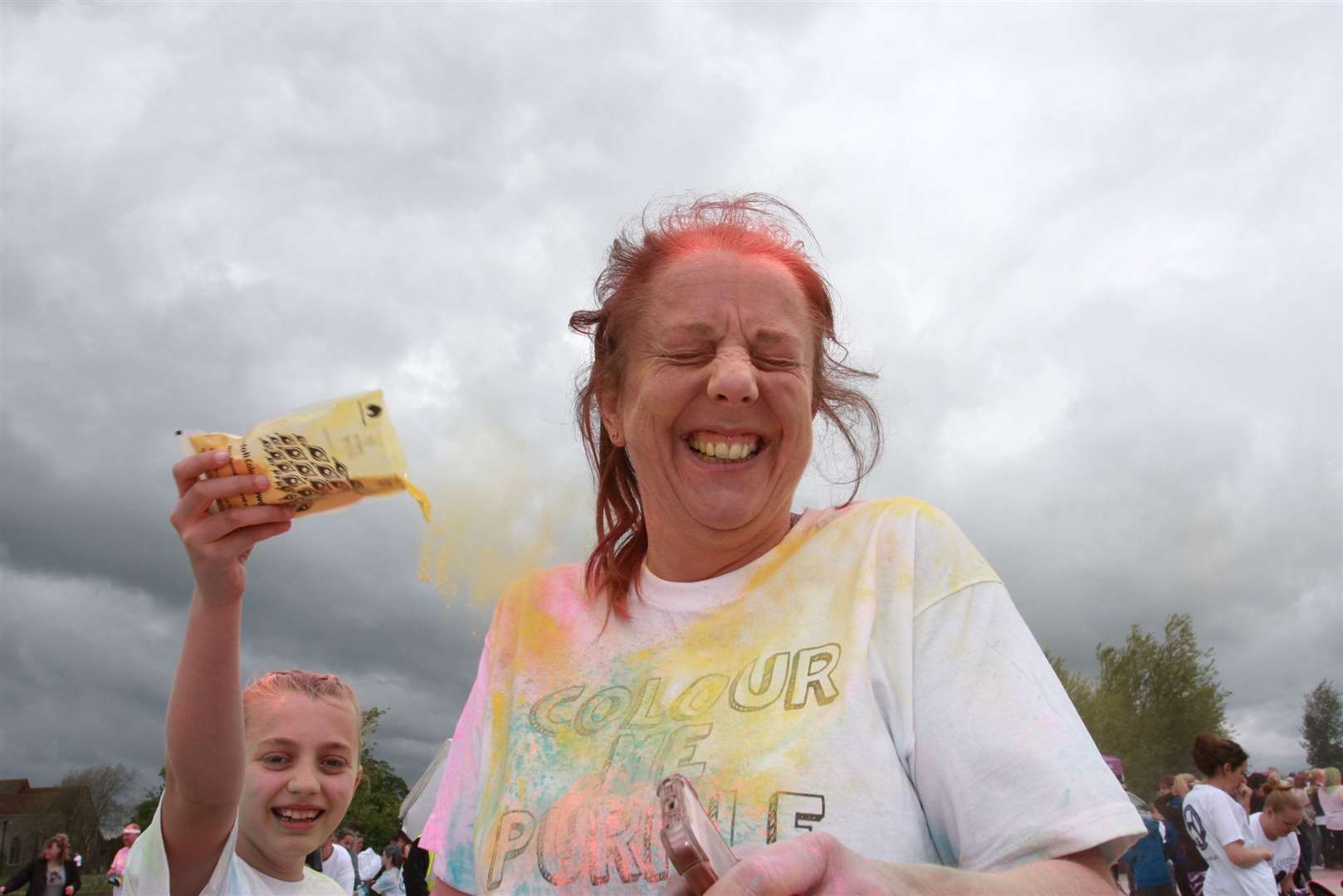 Competitors are pelted with coloured dye during the Colour Me Purple 5km run through Milton Creek Country Park for the Wisdom Hospice. Picture: Phil Lee