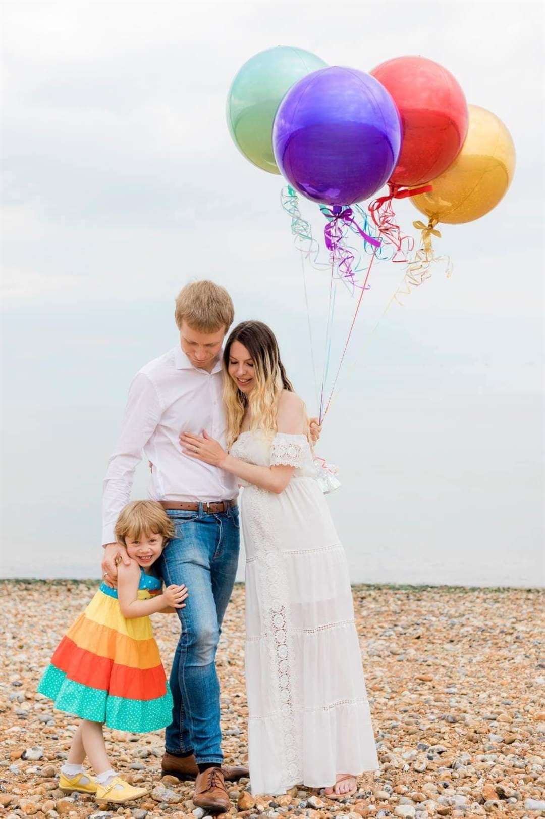 Laura Chesmer with her husband Dave and daughter Autumn in their a pregnancy announcement photograph. Picture: Robert Marriott