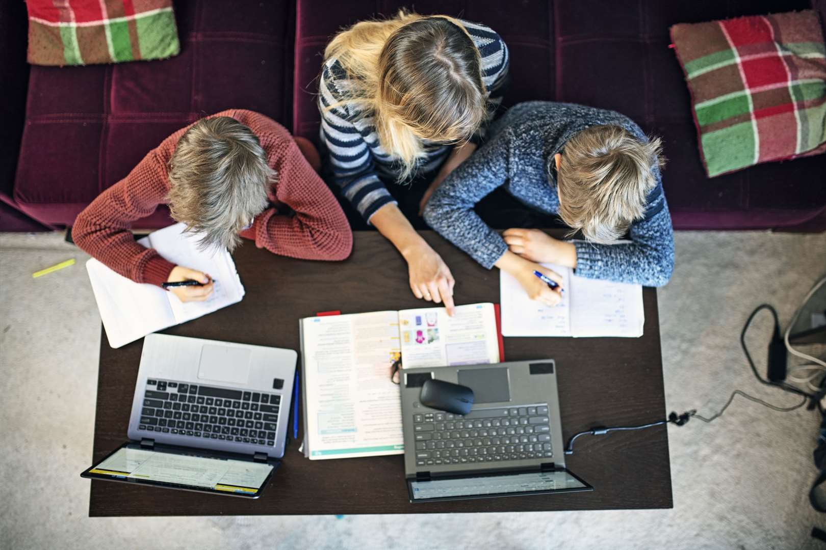 Mother helping sons with homeschooling at home during COVID-19 pandemic...Nikon D850. (44373313)