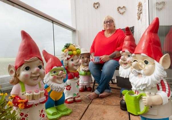 Janet Wilson on her balcony with some of her collection