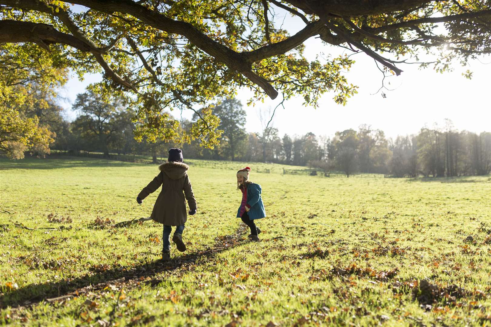 Children running in the autumn at Scotney Castle, Kent