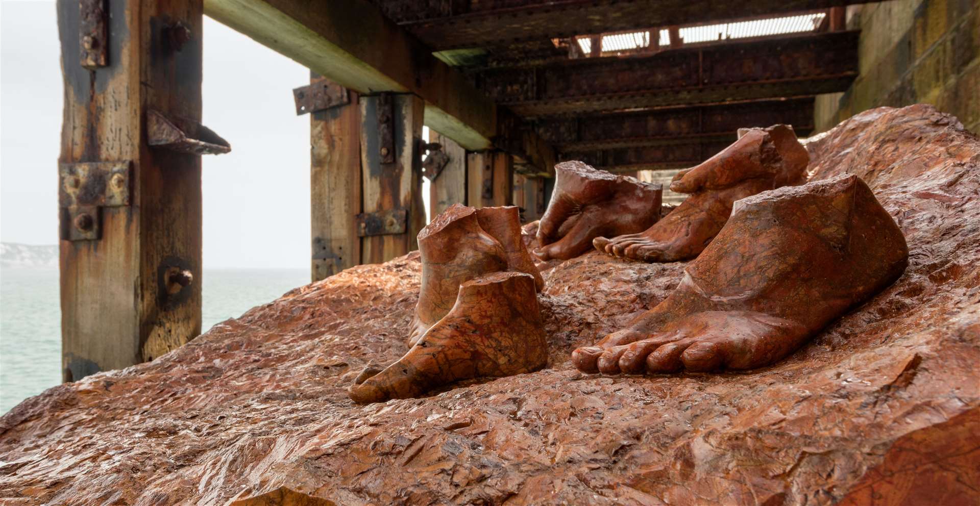 Dorothy Cross’ Red Erratic sees human feet emerge from a seven-tonne block on a loading bay at Folkestone Harbour Arm and aims to reflect the present-day realities of forced evacuation and migrations. Picture: Thierry Bal