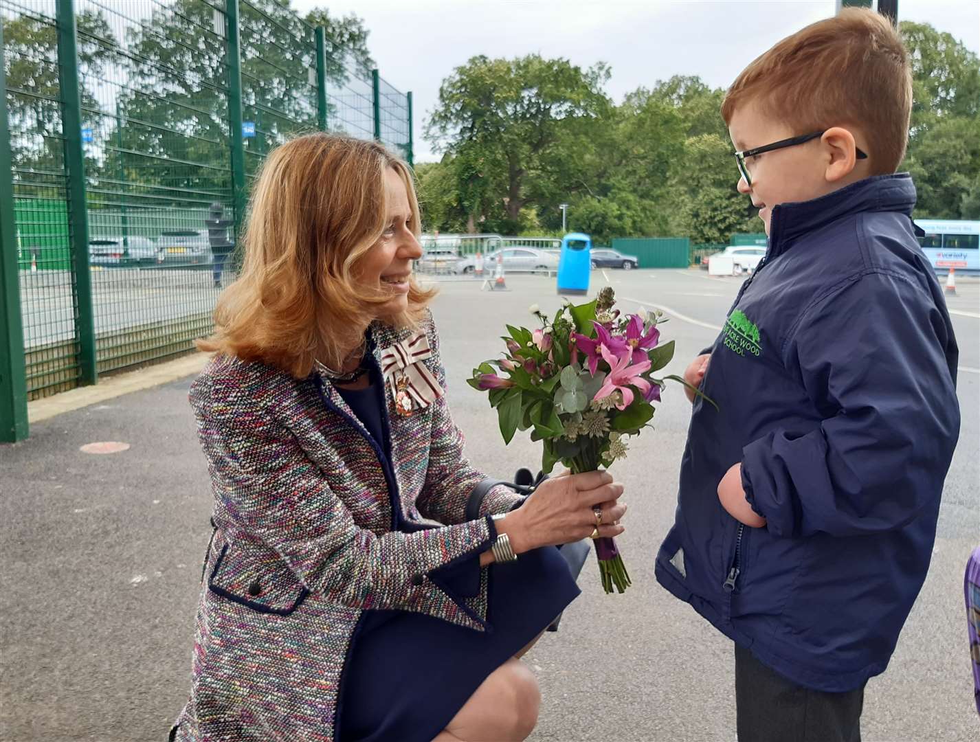 Five Acre Wood student Adam Finley presents flowers to the Lord Lieutenant of Kent, Lady Colgrain, who officially opened the pool