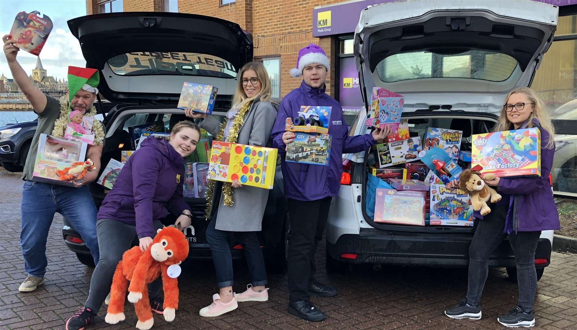 kmfm Street Teams along with breakfast show presenters Garry and Laura prepare to distribute the toys