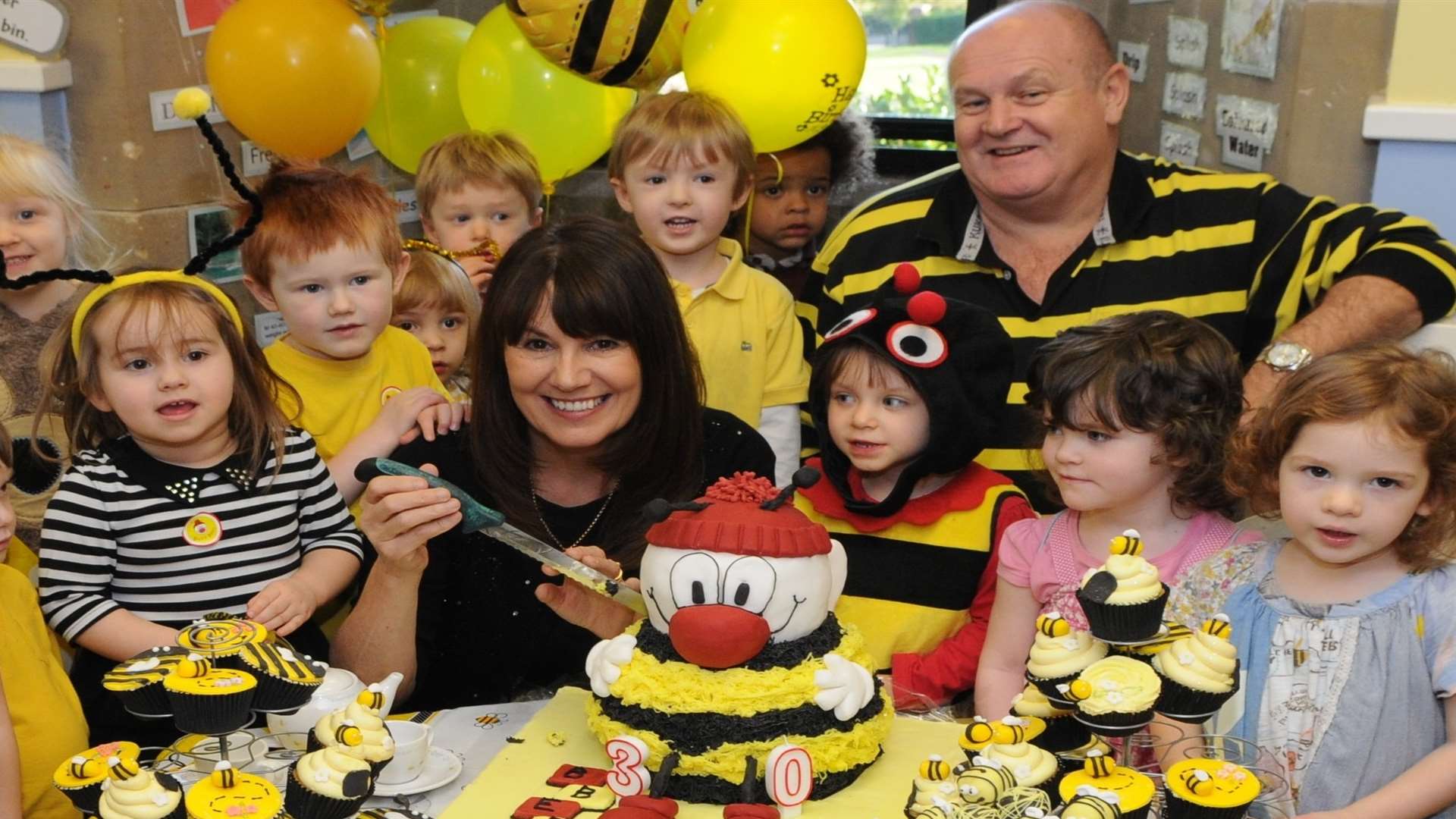 Busy Bees pupils enjoying birthday cakes with founders Marg Randles, managing director and John Woodward, chief executive officer. Picture: Katie Whirledge