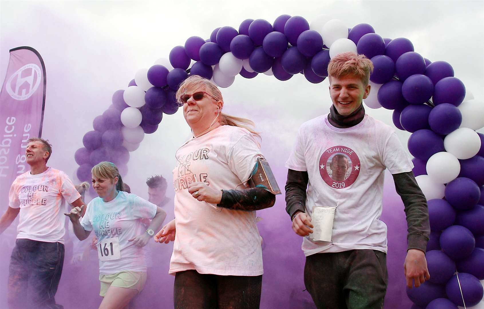 Competitors are pelted with coloured dye during the Colour Me Purple 5km run through Milton Creek Country Park for the Wisdom Hospice. Picture: Phil Lee
