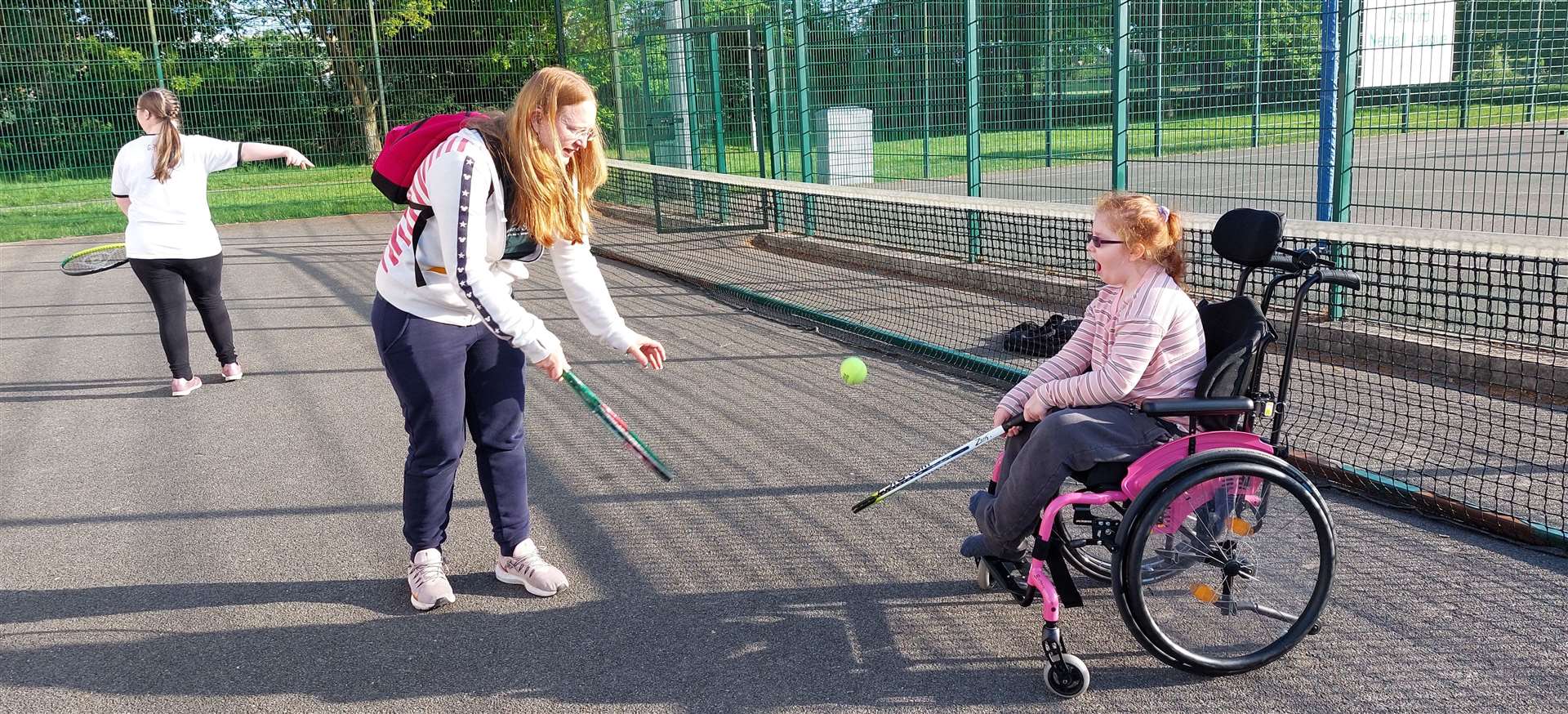 Amber playing tennis with her mum
