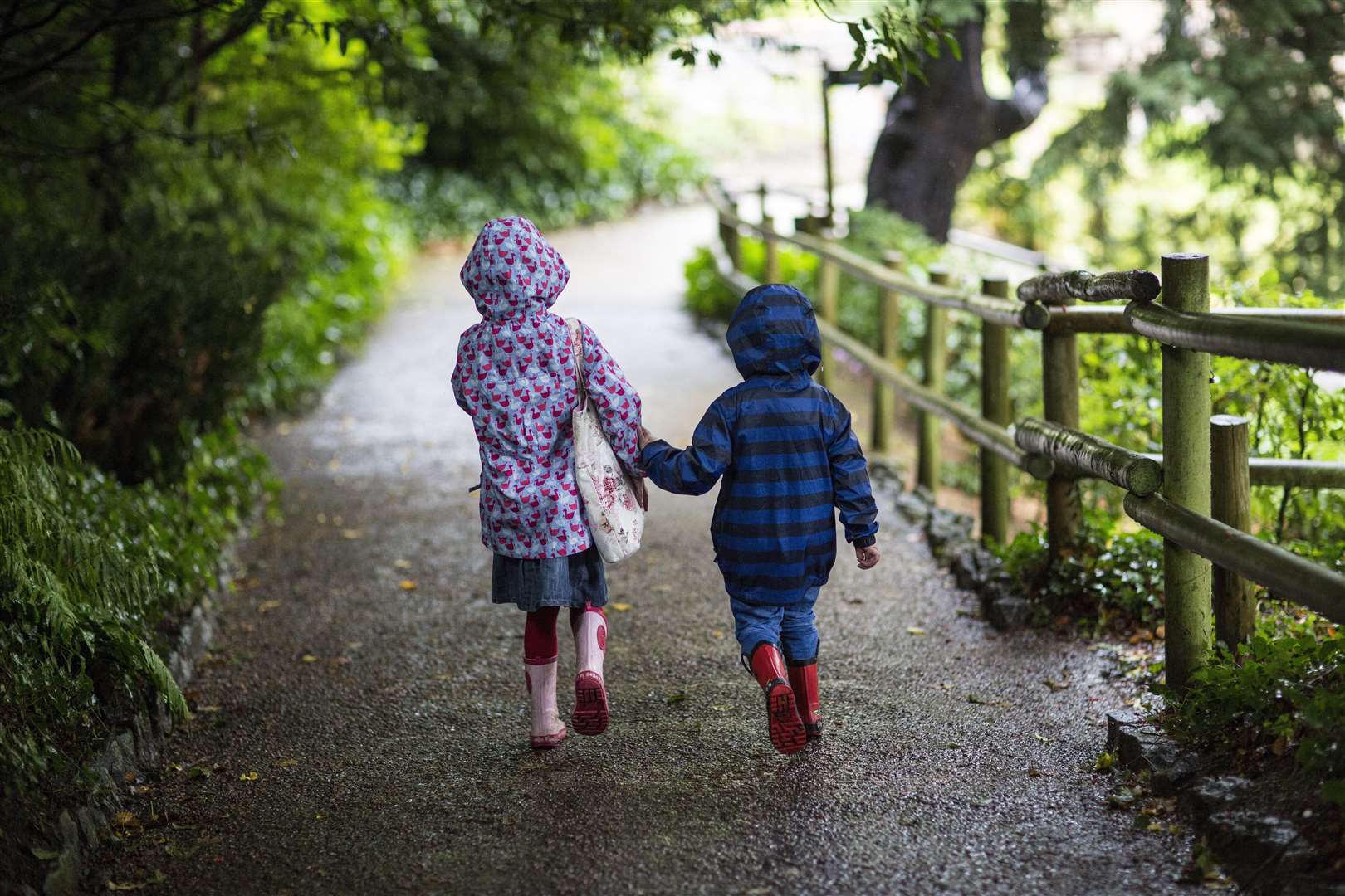 Children playing in the rain outside Ightham Mote, Kent. Ightham Mote is a medieval moated manor house near Sevenoaks. FM5066291. (2029682)