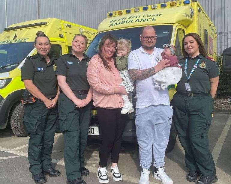 (From left to right) Ambulance crew Mandy Nash and Katy Ratchford, Chloe holding daughter Willow, Charlie holding daughter Autumn, and emergency medical advisor Rain Gavin. Picture: SECAmb