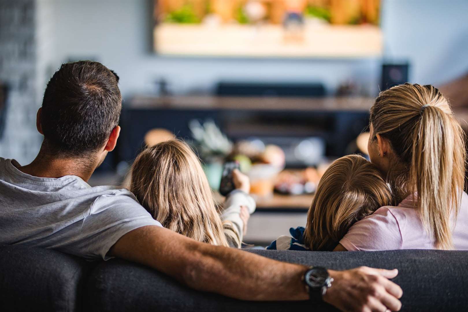 The Jones love sitting back and relaxing as they watch movies together. Stock picture