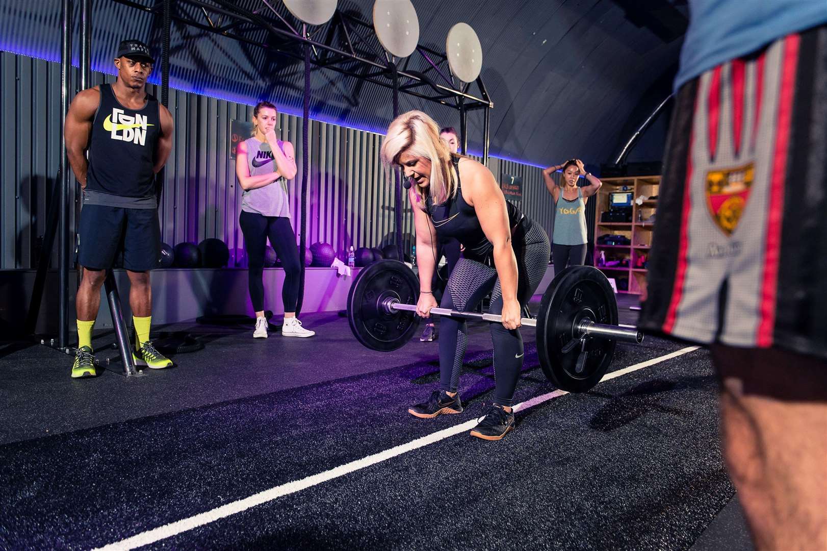 Laura demonstrating how to lift weights