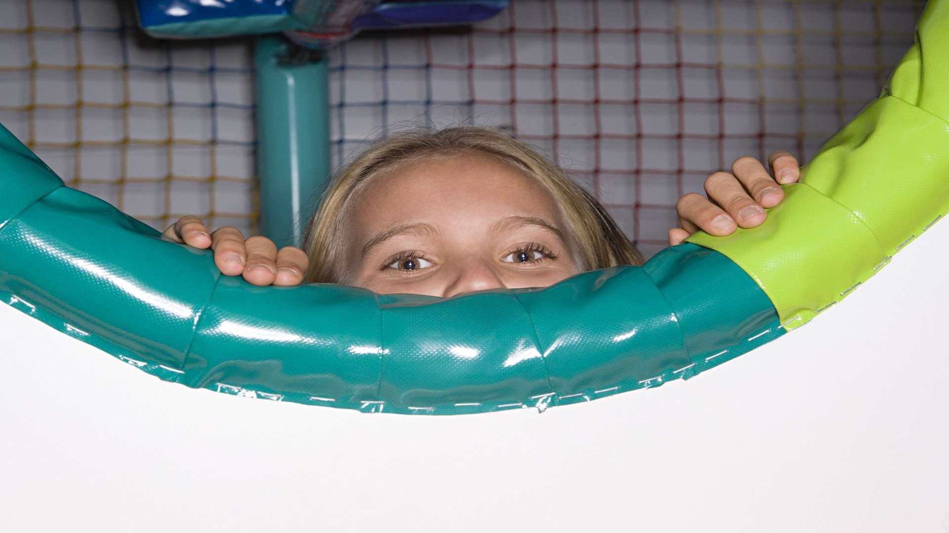 Girl in soft play area. Stock image.